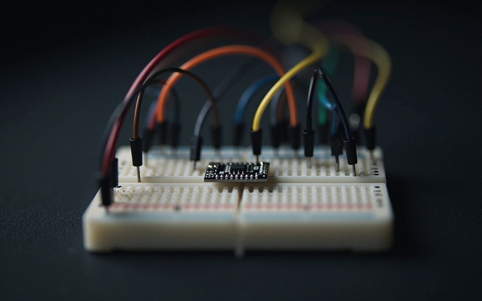 a breadboard with jumper wires, close up