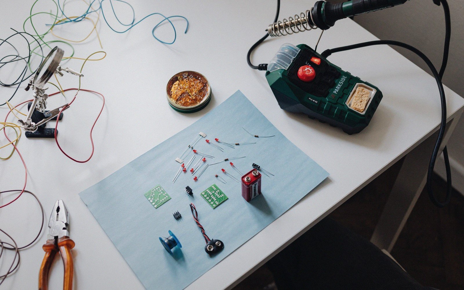 Soldering iron resting on a workbench